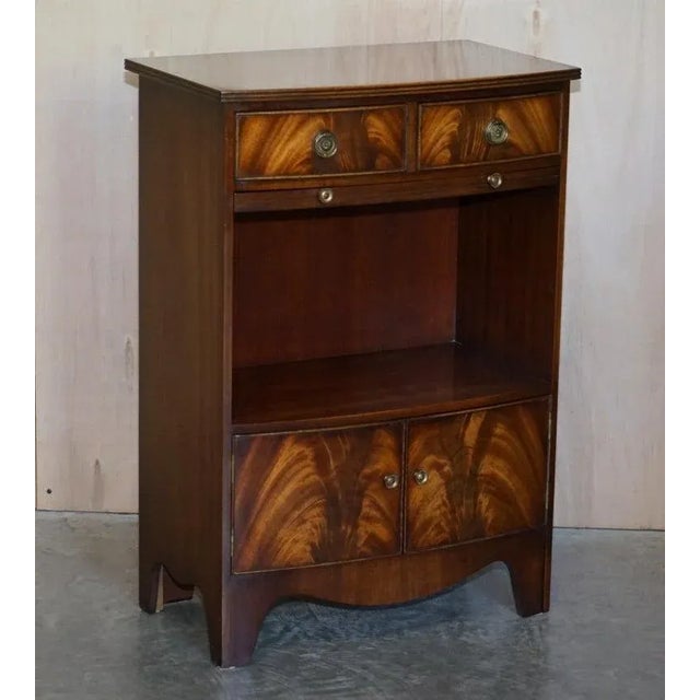 Sublime pair of Shaws of London, Flamed Mahogany, dwarf open book tables with butlers serving trays These are a very fine...