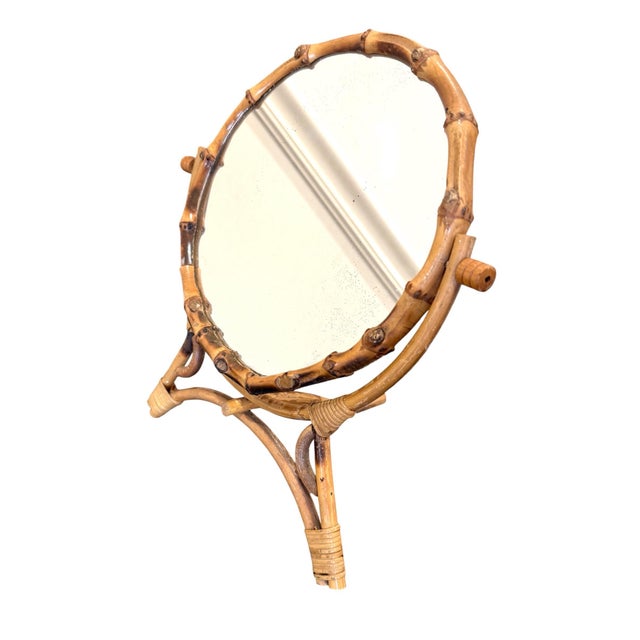 Vintage bamboo table mirror from France. Copper back. Round mirror that measures 8" in diameter. Tilts and folds flat.