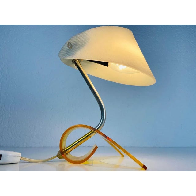 A beautiful table lamp made in germany in the 1970s. It has an orange base and a white shade. It is in very good vintage...