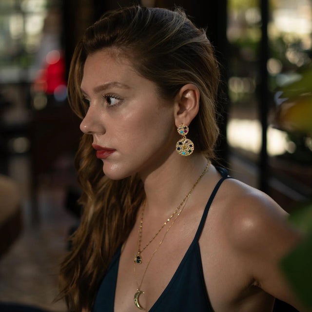 Elevate your look with the Celestial Harmony Multi Gemstone Gold Earrings, a statement design that blends bold elegance...