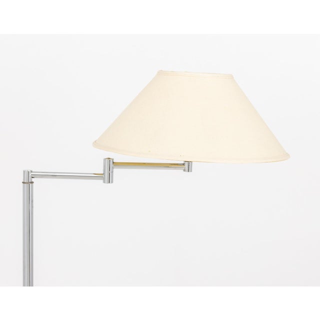 Nessen Studio Swing Arm Chrome Plated Floor Lamp, with white glass shade and articulated arm on circular base. Overall...
