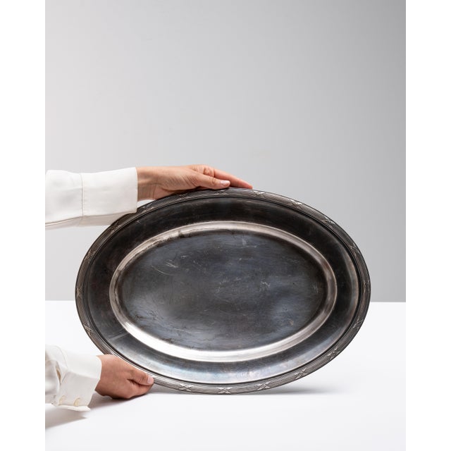 This mid 20th century plate from France is finished in gray, worked in silver. Its form follows honest, well-proportioned...