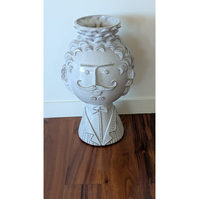 Oyster white vase, with face of a woman on one side and face of a man on the other side. unknown age. height 19.5", widest...