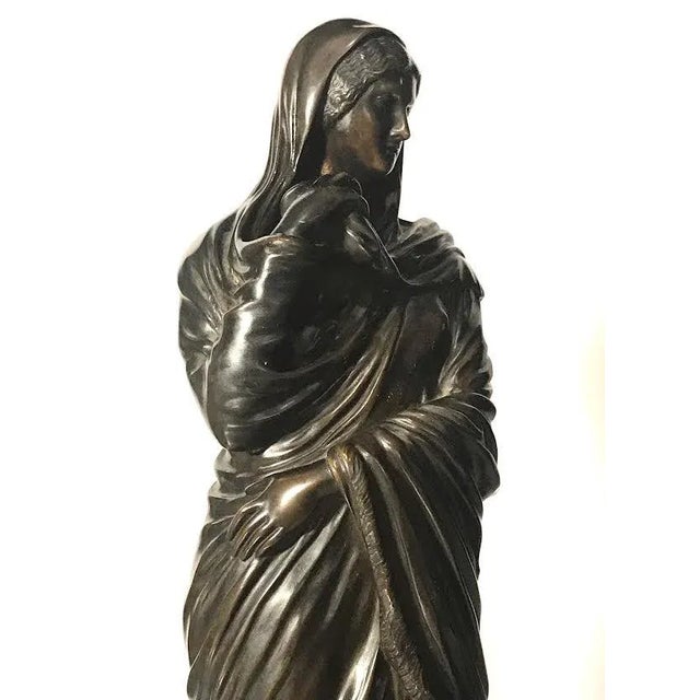 A beautiful original antique bronze of a classical woman on a stone base. Measuring 8.0" W x 21.0" H x 6.5" D in good...