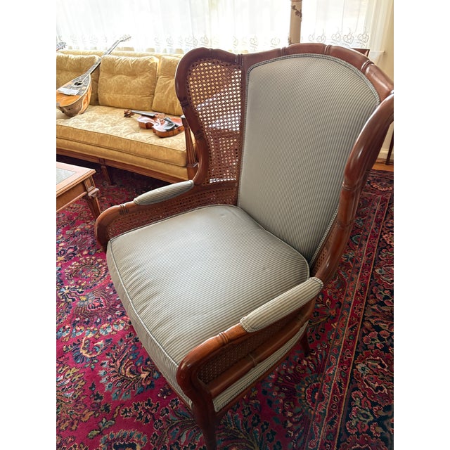 Ethan Allen Regency Faux Bamboo and Cane Wingback Upholstered Lounge Chair. Key Features • Frame: Sculpted walnut frame in...