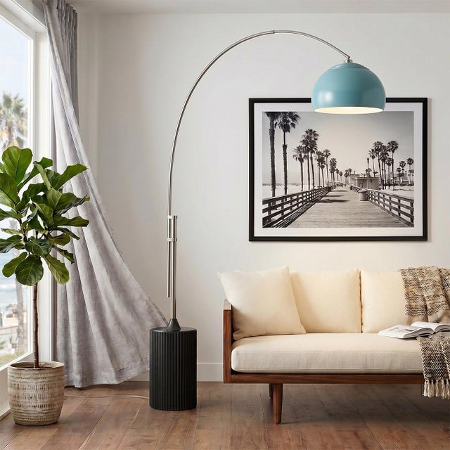 The Tambo Arc Lamp is a striking Mid-Century Modern lighting piece designed by Peter Morelli in 1984. This arc lamp...
