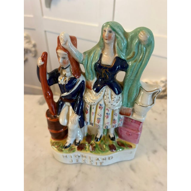 A charming antique Victorian Staffordshire pottery flatback figure titled Highland Jessie. Beautifully modelled and hand-...