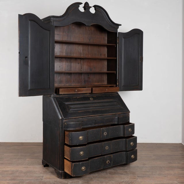 Late 19th-century 8' tall Swedish oak bureau or secretary featuring a newer professionally applied black layered painted...