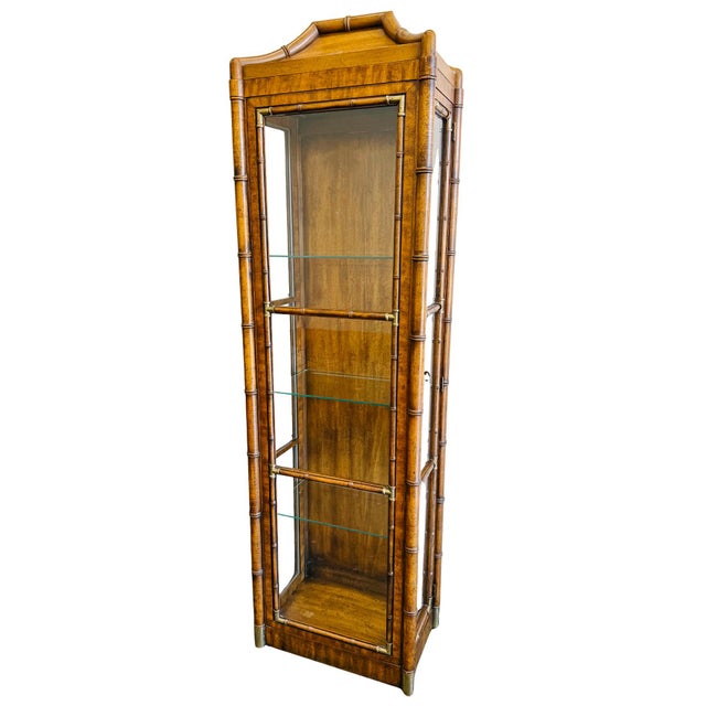 A striking Hollywood Regency glass display vitrine by Weiman. Made during the 1970s Chinoiserie revival era, this tall,...