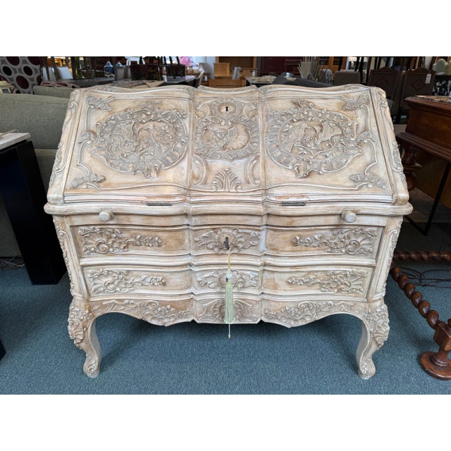 Design Plus Gallery presents a Louis XV Carved Bleached Oak Wood Secretary. The desk has elegant carved detailing, curved...