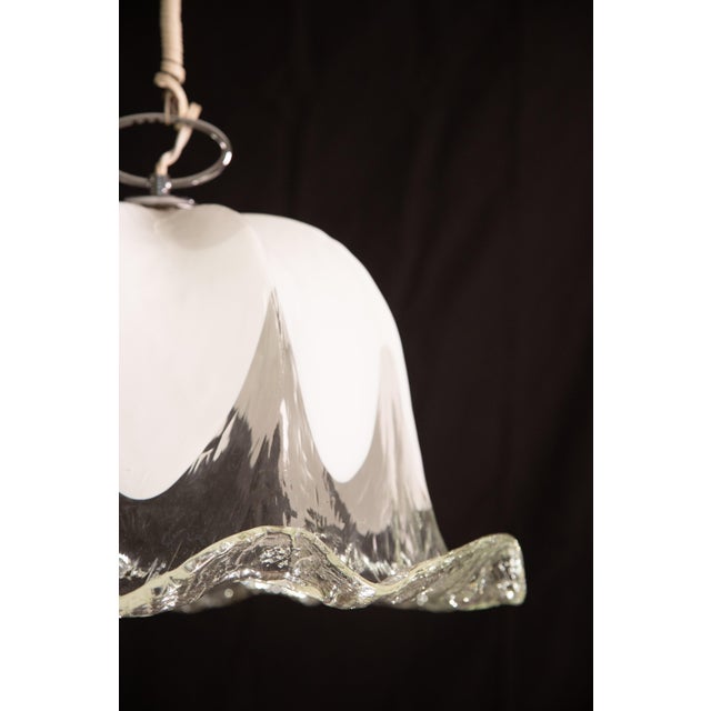 Pretty ceiling lamp made of blown Murano glass in white and transparent color. Accommodates an E27 bulb, European...