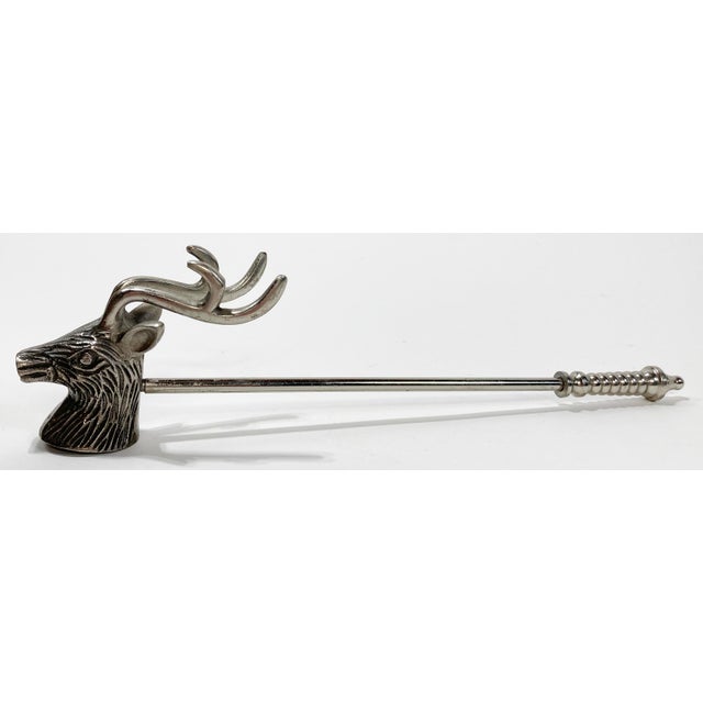 Ornate vintage candle snuffer in the shape of a stag deer. Features silver finish and a long decorative handle. Patina to...