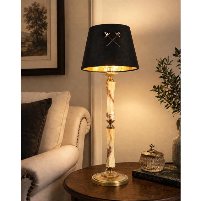 Column table lamp dating to the 1950s, combining natural onyx with brass fittings and a round brass base. The stone...