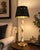 Column table lamp dating to the 1950s, combining natural onyx with brass fittings and a round brass base. The stone...