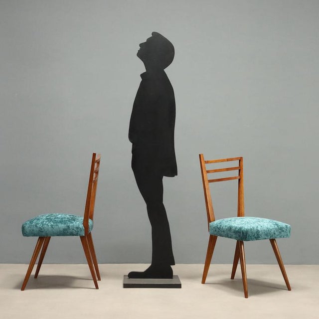 Five Italian-made chairs from the 1950s-60s, featuring a distinctive design reflected in the unique backrest and elegant...