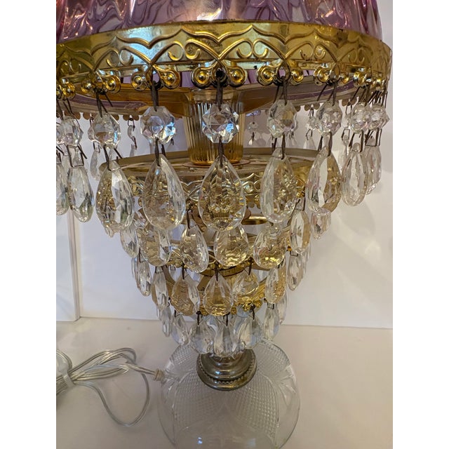 Ornate glass dome with cut glass features in amethyst color set atop 4 tiers of teardrop shape crystal prisms make up this...