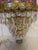Ornate glass dome with cut glass features in amethyst color set atop 4 tiers of teardrop shape crystal prisms make up this...