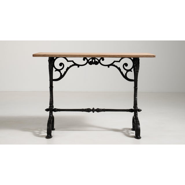 A classic French bistro table with an ornate cast iron base and compact top, designed for durability and frequent use. The...