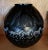 A magnificent and striking Lalique France black crystal vase titled "Tanzania". Sculpted in a dramatic spherical form,...