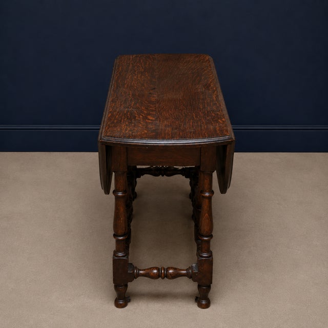 This table features a compact, versatile design with hinged side leaves that can be raised to create a larger surface or...