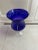 Beautiful blue - cobalt blue glass with clear pedestal base . Scalloped edge on top rim. Use for candles, flowers or any...