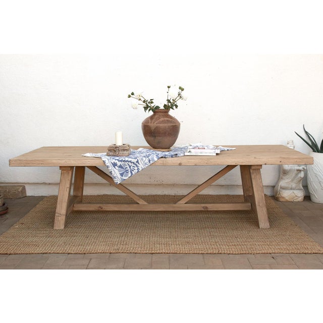 Ten feet of reclaimed wood on a trestle base built the way farmhouse tables have been built for centuries: two angled...