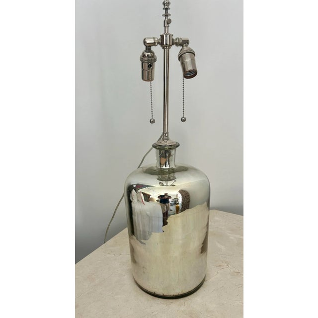 A luminous and sculptural pair of vintage mercury glass lamps, crafted from repurposed mercury glass jars with beautifully...