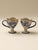 A set of vintage ceramic cups featuring petal-shaped rims and hand-painted blue floral patterns. With their unique design,...