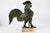 An antique three-dimensional, hollow rooster weathervane figure in profile with a full comb, wattle and sweeping tail...