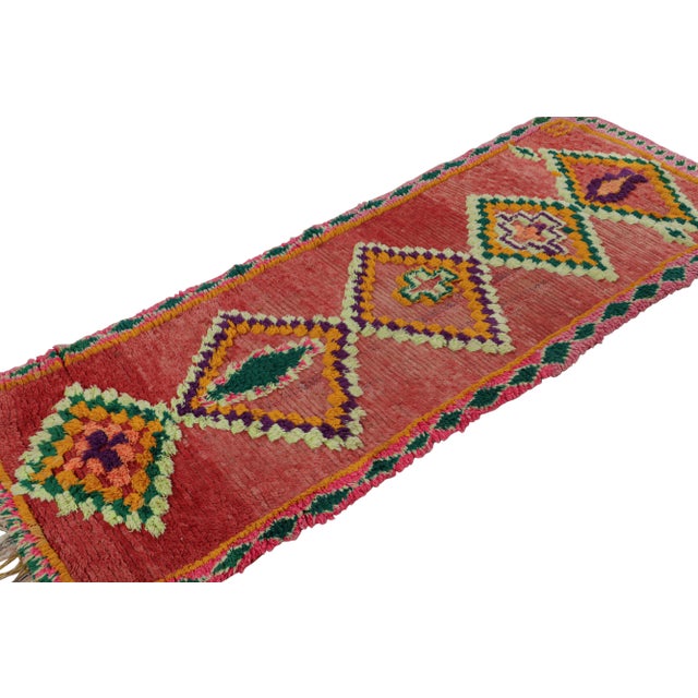 Hand-knotted in wool circa 1950-1960, this 3x8 vintage Moroccan runner rug with diamond medallions, hails from the Azilal...