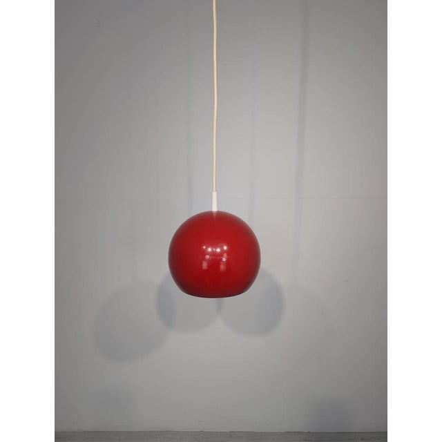Topan VP6 Spherical Pendant Lamp, Designed by Verner Panton, 1960s This red sphere-shaped pendant lamp, the Topan VP6, was...