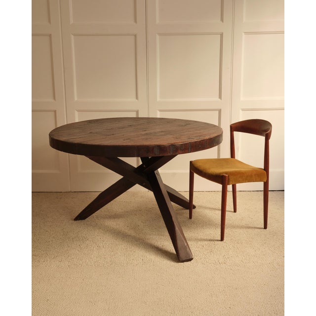 Circular table - Netherlands 1950s Solid wood table featuring a thick, circular top worked with a gouge to create linear...