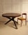Circular table - Netherlands 1950s Solid wood table featuring a thick, circular top worked with a gouge to create linear...