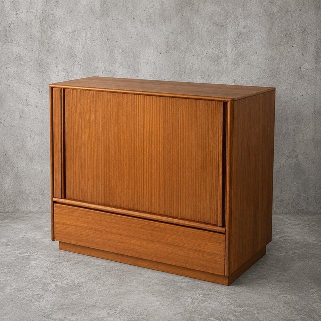 with its warm teak grain, minimalist proportions and functional Danish design, it works equally well as a cocktail...