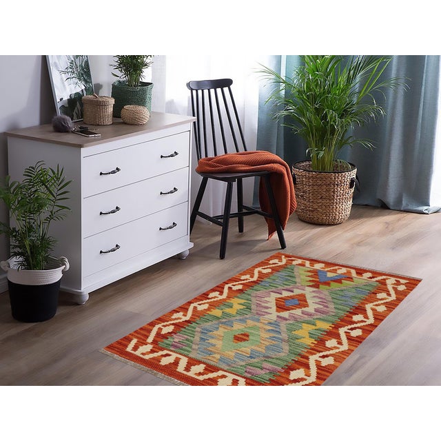 Elevate the elegance of your home with this stunning hand-woven tribal Kilim wool rug. Meticulously crafted on a loom by...