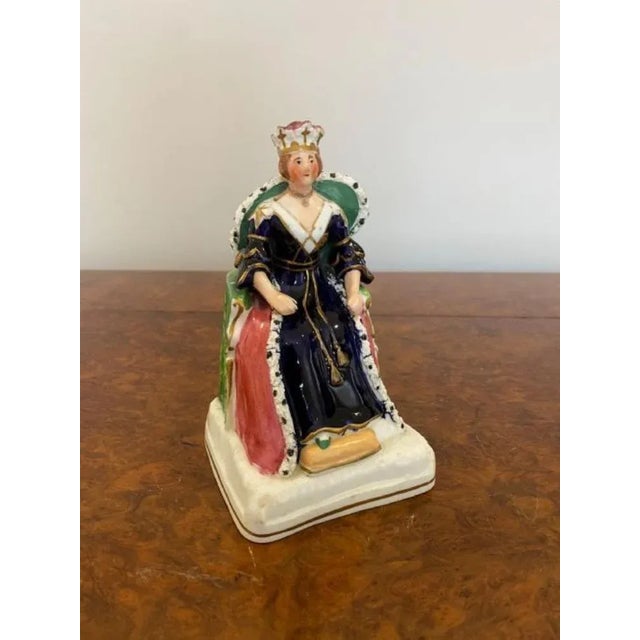 19th century antique Staffordshire royal portrait figure of Queen Victoria seated on a square gilt lined base, with both...