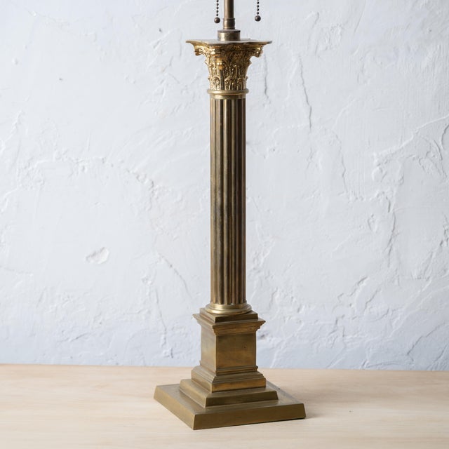 A brass corinthian column lamp, 19th century. Electrified and sold by Sentimento Antiques. 6 inches wide by 6 inches deep...