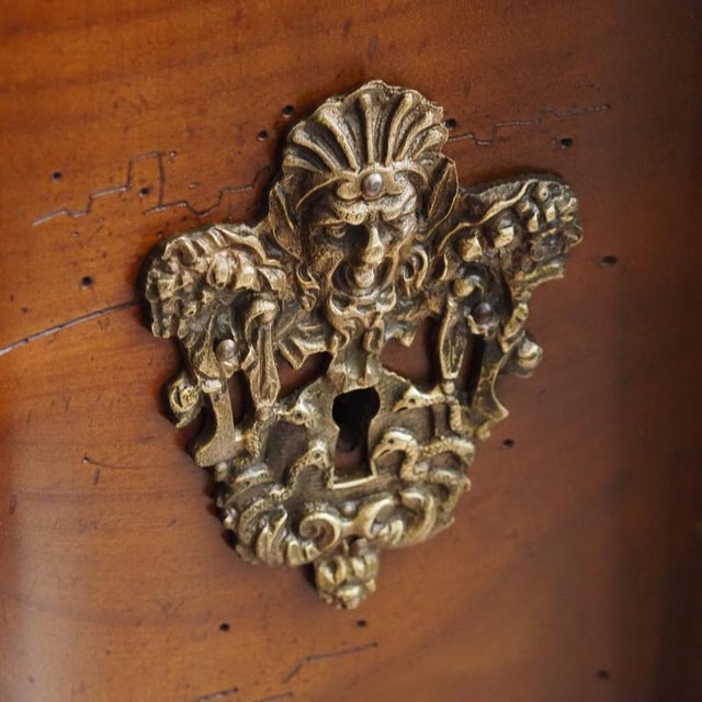 Three-drawer Louis XV-style commode with a continuous, curved arbalète front, crafted in cherry wood with figurative...