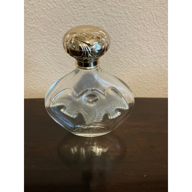 Vintage Nina Ricci L’Air du Temps perfume empty bottle, featuring the iconic Lalique dove motif on clear glass and an...