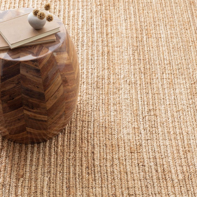 Striations of corded woven jute recall driftwood boughs, pummeled soft and smooth by waves and weather. Elemental elements...