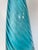 An elegant vintage hand-blown art glass floor bottle featuring a striking optic swirl design in luminous aqua blue glass....