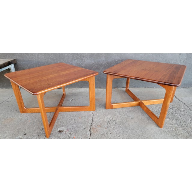 Fine pair of teak Danish Modern end or side tables with a sculptural X base design. Exceptional quality as the tables are...
