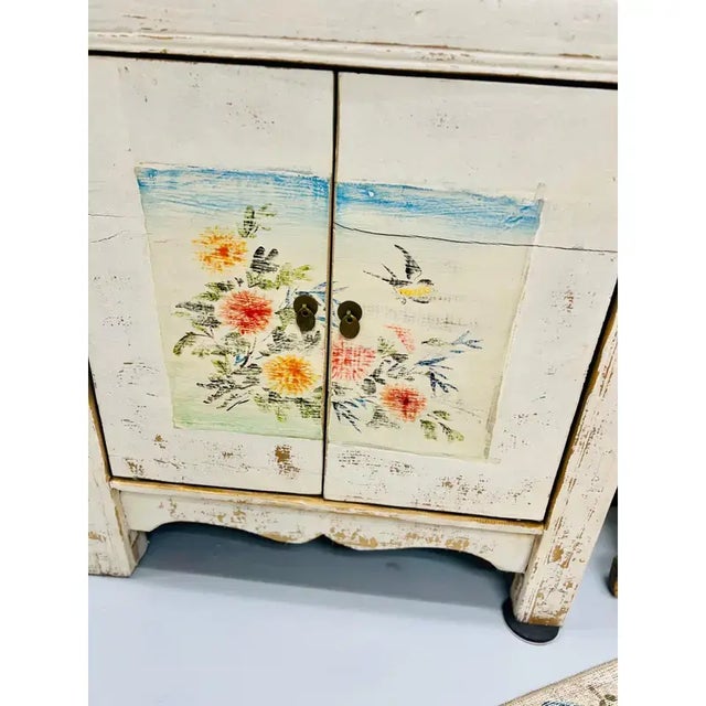 This one-of-a-kind vintage sideboard cabinet features handprinted floral motifs on the front. Dating from the early...