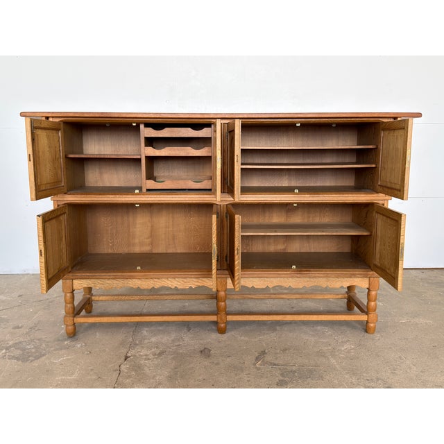This tall oak sideboard was produced by Axel O. Røck for Ottrup Møbelfabrik in Denmark, dated 18 November 1963 by the...
