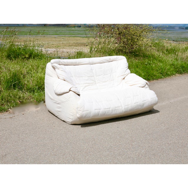 Vintage sofa from the late 1970s, foam and white fabric. Very comfortable. Small stains visible on the sides and back. One...