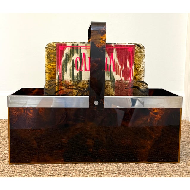Large faux tortoise lucite magazine holder. Chrome band. Top Handle. Interior holder with three sections that can be...