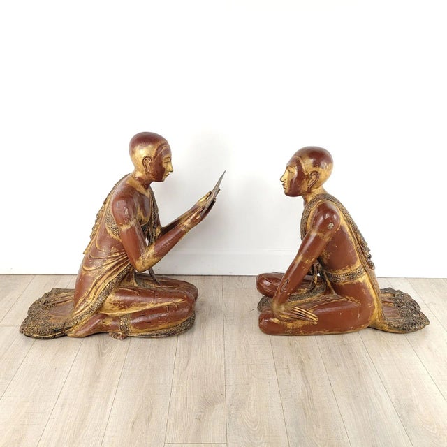 A large pair of Southeast Asian wooden lacquered and gilt monks, 20th century.