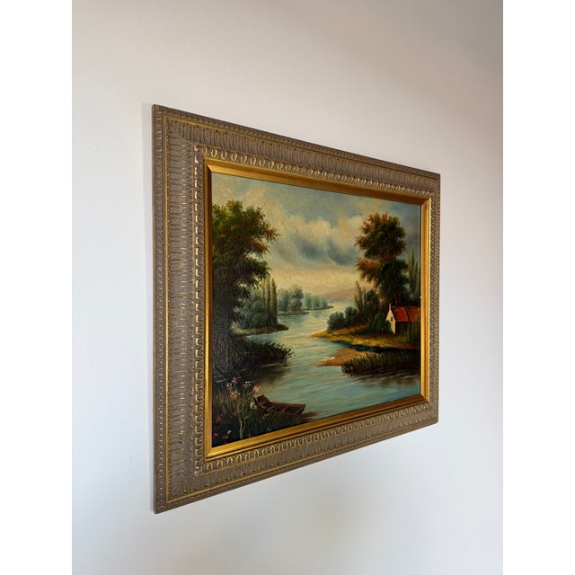 Charming vintage oil painting on canvas depicting a peaceful European countryside river landscape with lush trees, a small...