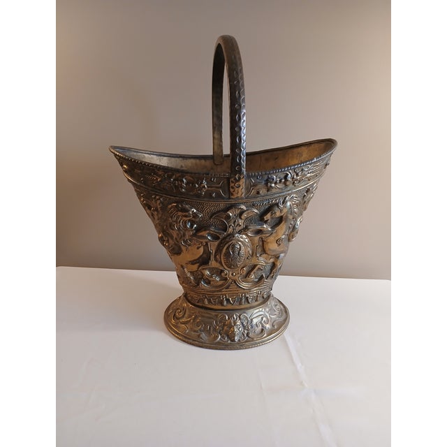 Unique antique brass coal scuttle bucket. It is in lovely shape for age. Front and back are flanked with a unicorn and a...