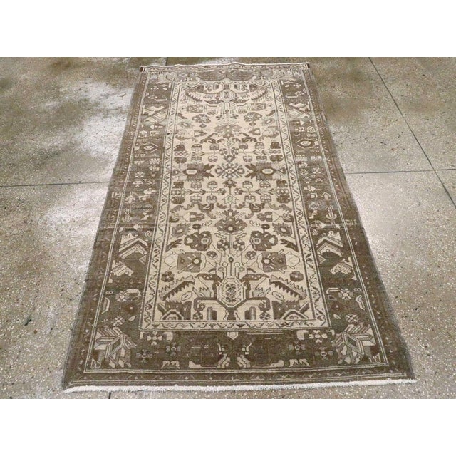 A vintage Persian Malayer accent rug. The light sand field of this rustic west Persian scatter displays flowering turtle...